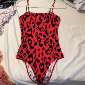Pink cheetah print body suit